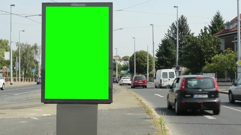 CZECH REPUBLIC, PRAGUE - JULY 7, 2015: billboard by the busy road in the suburb - green screen - car pass 