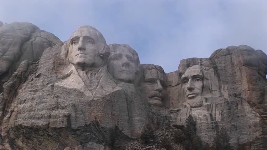 Different views of Mt. Rushmore on a cloudy day.