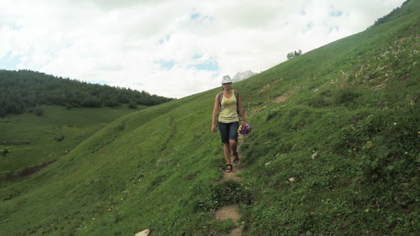 Path in alpine meadows woman