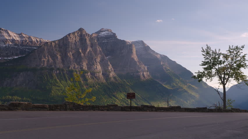 Convertible car passing the camera on Going to the Sun road in Glacier National Park.  Montana. 4K