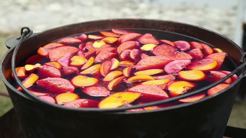 Cast iron pot with mulled wine. Russian holiday Maslenitsa