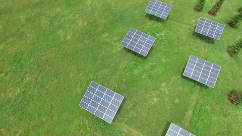 A 4K aerial of a group of solar panels in a green field