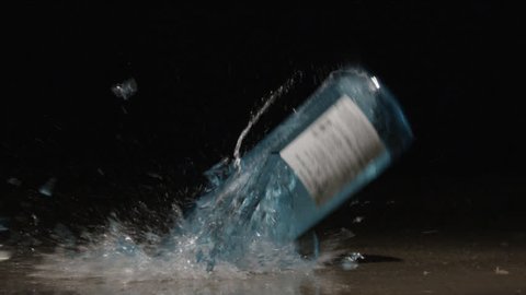 Slow Motion Glass Bottle Falling Smashing Breaking Splashing