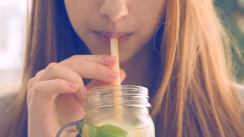 Girl drinking lemonade.