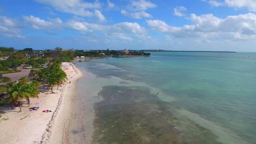 Aerial video of Key Biscayne shallow waters and people swimming