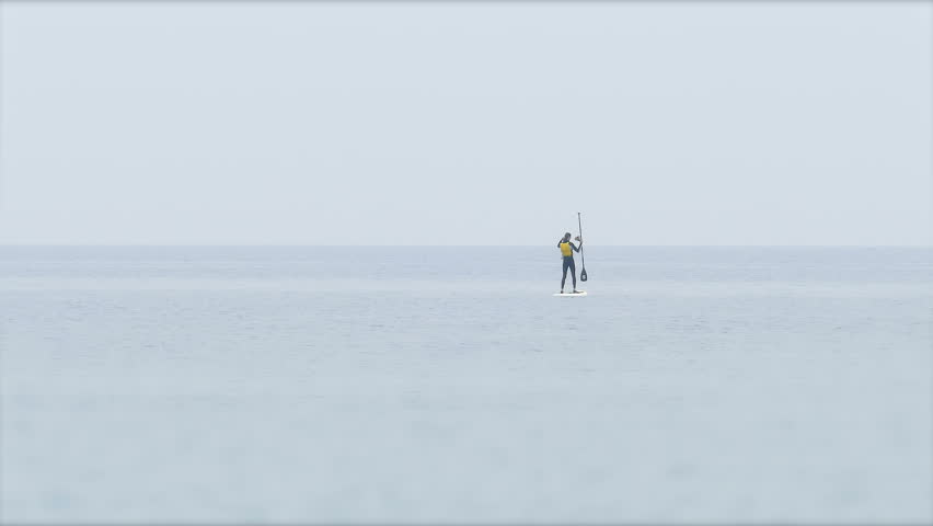 Barcelona A lonely man doing stand up paddling in the Mediterranean Sea, Barcelona/ Stand up Paddling in Barcelona
