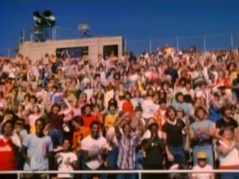 Spectators cheering in bleachers, 1980