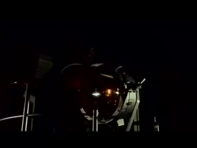 Man on deck of ship turning on searchlight, 1960s