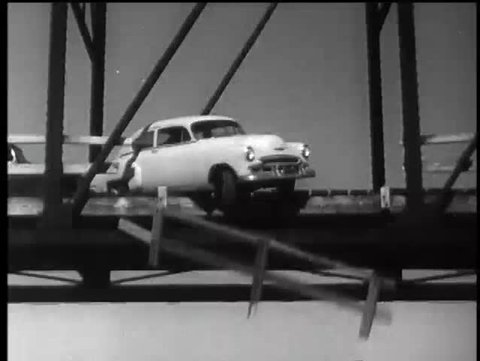 Car falling from bridge into river, 1960s