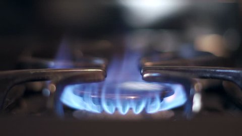 Stove top burner igniting into a blue cooking flame in 4K UHD. See my portfolio for other angles and slow motion speeds (60fps-180fps).