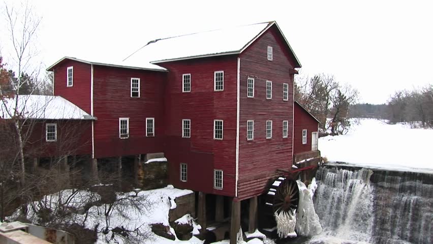 Classic old mill with waterwheel during winter