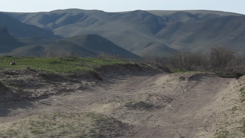 Wind drives the clouds of dust on the dirt road