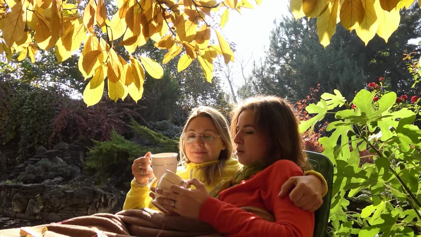 Picturesque autumn landscape. Friendly communication and a tea party at the pond in the foothills of the Caucasus mountains.