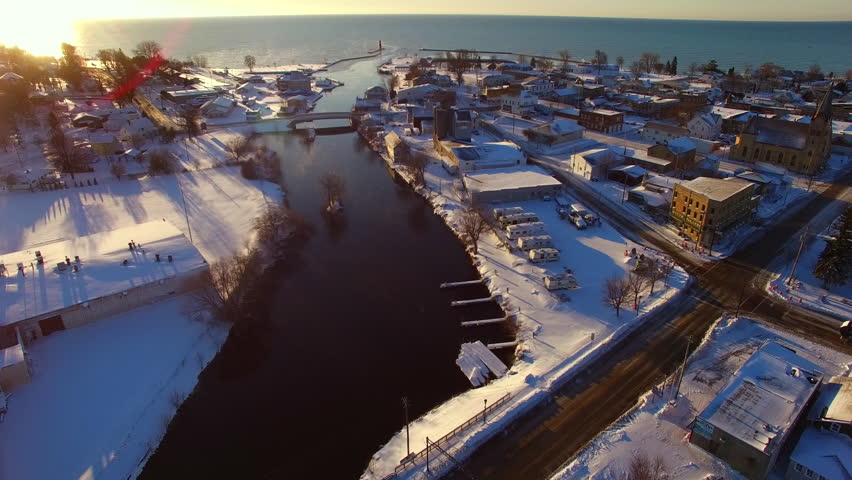 Sunrise aerial flyover of steaming cold Ahnapee River in Algoma Wisconsin.

