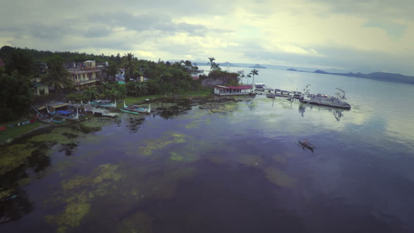 Fisherman paddling the boat in Taal Lake