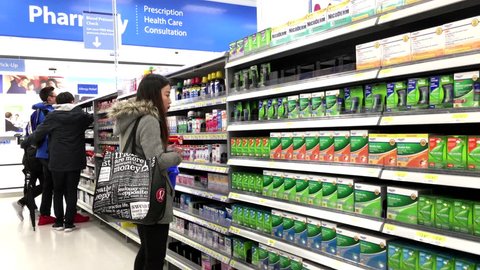 Coquitlam, BC, Canada - March 23, 2016 : People taking medicine at pharmacy section inside Walmart store with 4k resolution