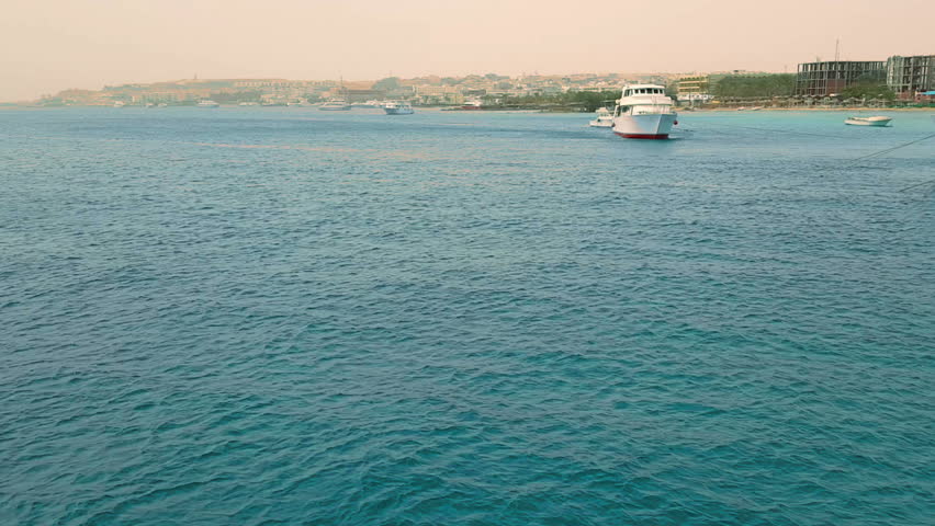 The yacht is moving in the azure sea