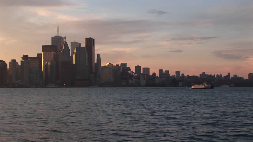 Boats move across Lake Ontario with Toronto skyline in background