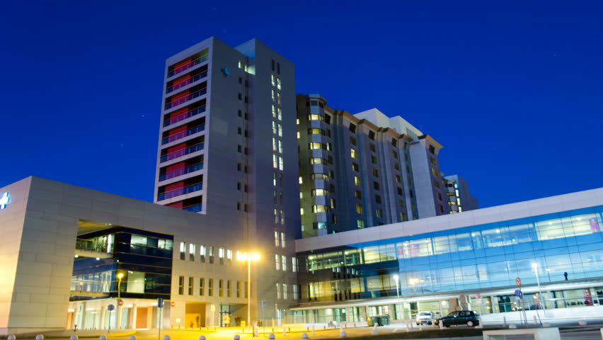 Generic Health Care Modern Hospital Exterior Building at night. Time Lapse