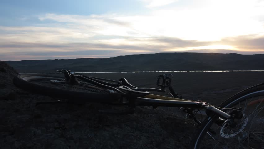  cyclist leaving the bike admiring the sunset