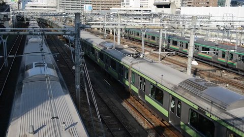 Passenger Trains moving in Ueno Station with rail cars and train tracks, HD video