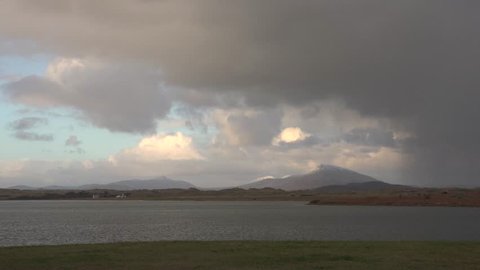 Time lapse of the Muckish with moving clouds and rainbow, Donegal, Ireland