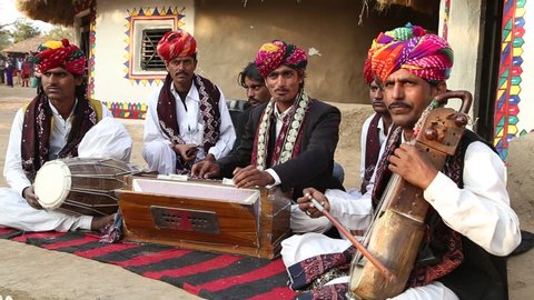 Udaipur, India - December 24, 2015 : A group of traditional and cultural folk singers called Manganiars and Langas singing the famous song "kesaria balam" at a cultural fair at Shilpgram in Udaipur