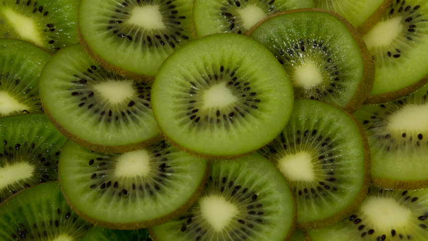 Fresh Kiwi Slices Close-up Rotating. Seamless Looping Motion.