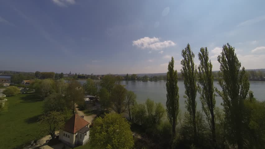 Time-lapse recording on the lake of constance during summer with blue sky, fast moving clouds from high above