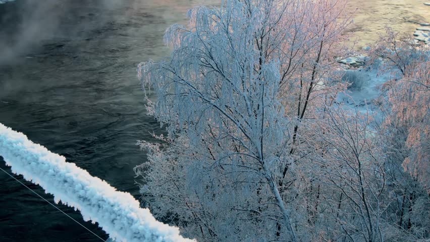 Winter river and railway bridge. Sunset