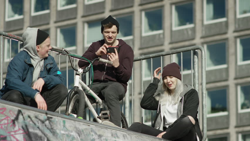 boy making video of a skater performing tricks