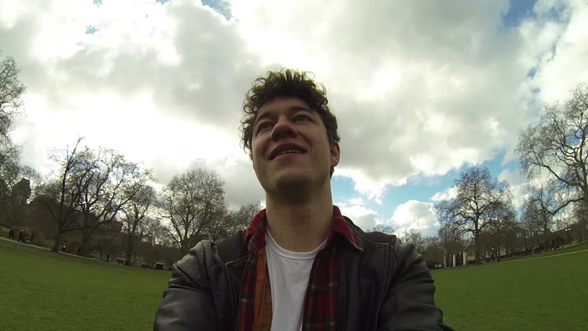 Boy playing and spinning around at park. Video shot with an action cam mounted on a gimbal to smooth the movement