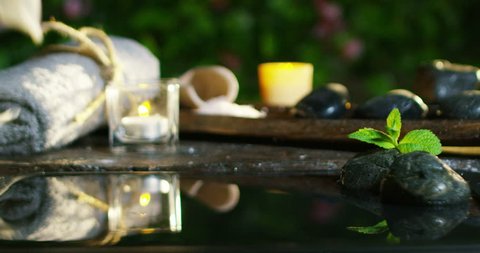 beautiful water and candles spa and wellness composition shoot in extreme slow motion 