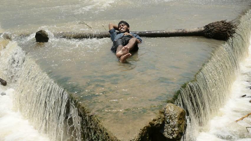 Indian man sleeping in the river