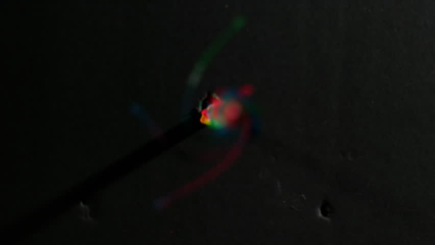 Rack Focus Rainbow -  a power drill bit loaded with colors spins dead onto camera as the focus racks towards the front - alpha matte, phantom 4k Royalty-Free Stock Footage #15614527