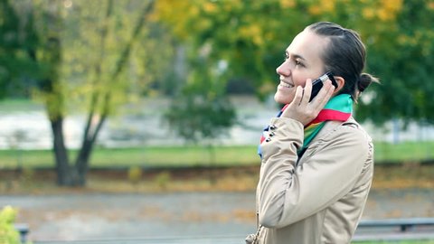Young attractive woman talking on mobile phone, outdoors