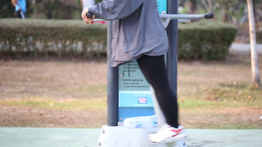 People on swing exercise equipment