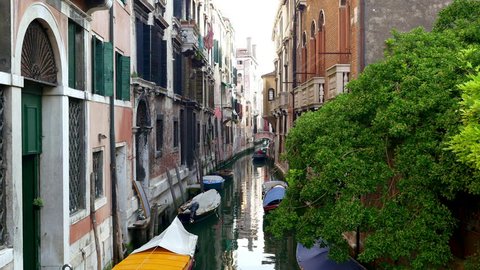 Venetian canal with moored boats. 4K UHD video.