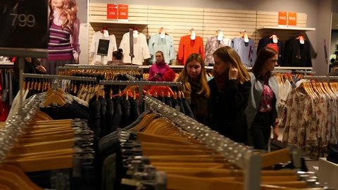 KHERSON, UKRAINE - MAR 25, 2016: Open concert and shopping day festival - Interior of a fashionable clothes store in a big mall - people shopping