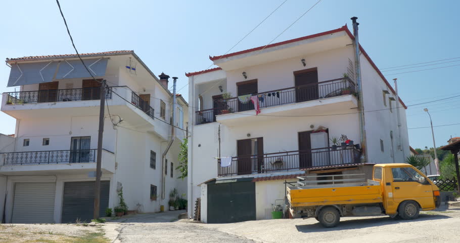 View on two blocks of flats and yellow parked car in the street