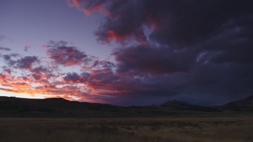 Amazing colorful sunset with dramatic clouds in Yellowstone National Park, Wyoming and Montana, USA. 4K.