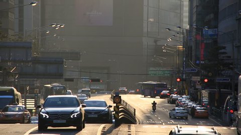 Seoul, South Korea_30 March 2016 : City traffic on uphill road in downtown Seoul at sunset