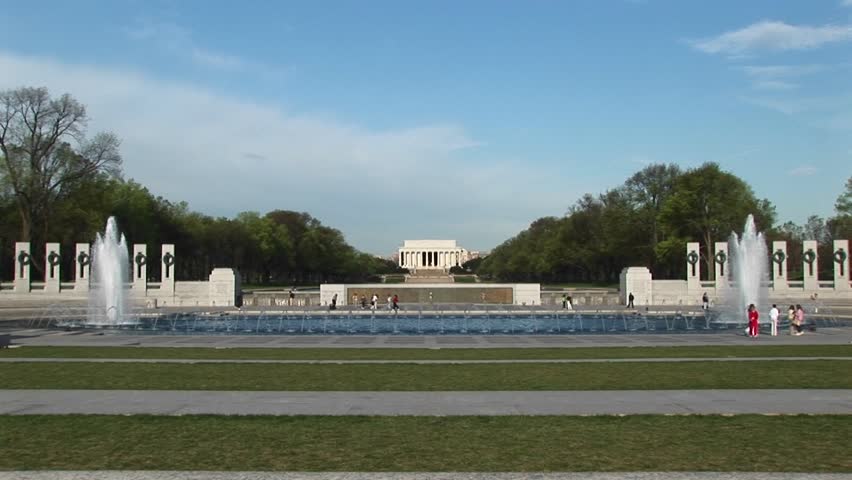 A beautiful view of the Lincoln Memorial in the distance with the reflecting pool and fountains in the foreground