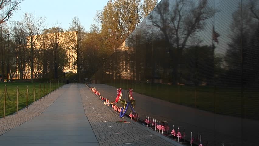 In front of the Vietnam Veterans Memorial Wall, ribbons on tributes and mementos flutter in the breeze.