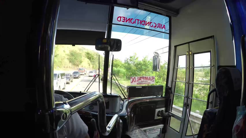 MANILA, PHILIPPINES - APRIL 3, 2016: transport, transportation, tourism, road trip and people concept - close up of driver holding wheel driving passenger bus
