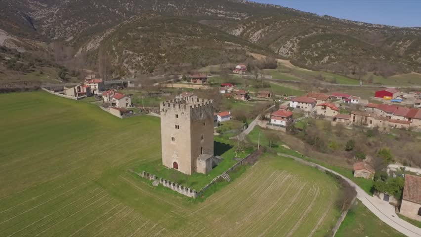 Spain, burgos, Las Merindades. March 2016. Aerial views of Los Velasco Tower, little castle built on XIV and Romanesque Church of Saint Miguel built on XII and located in Valdenoceda,Castile and Leon