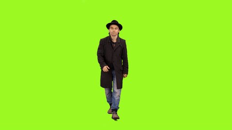 Front view of a man walking & smiling on a green screen background, Full HD shot with alpha channel