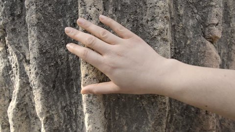 hand touching an ancient column as concept of love to historical architecture