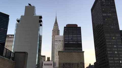 NEW YORK CITY – OCTOBER 2015: Manhattan skyline at sunset from a rooftop. The city attracts 50 million people annually.
