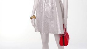 White dress in the wind. Red handbag and white dress. Stylish dress on light background. Trendy garment with expensive accessories.
